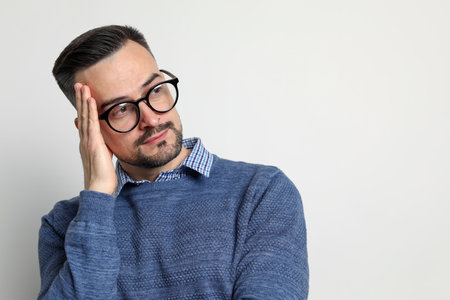 Portrait of handsome middle aged man on light background, space for textの写真素材