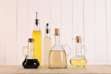 Bottles of salad dressings on wooden tableの写真素材