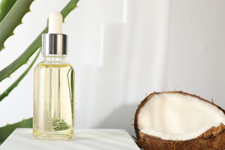 Hair treatment. Cosmetic product, coconut and aloe leaves on white background, closeup. Space for textの写真素材