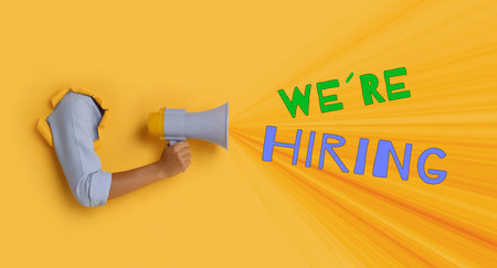 Woman holding megaphone through hole in orange paper, banner design. Human resource, recruitment conceptの写真素材