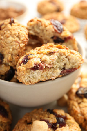 Delicious oatmeal cookies with raisins and nuts on table, closeupの写真素材