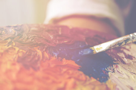 Artist mixing paints with brush on palette, closeupの写真素材