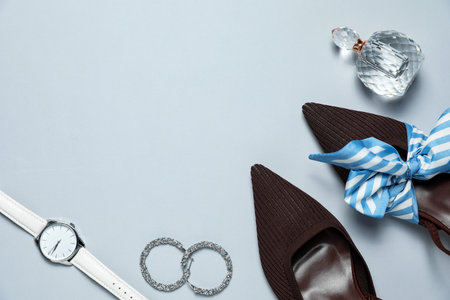 Flat lay composition with jewelry, accessories and shoes on light grey background. space for textの写真素材