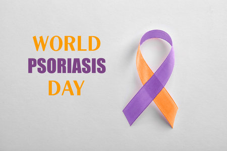 World Psoriasis Day. Orange-orchid awareness ribbon on white background, top viewの写真素材