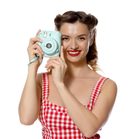 Happy pin-up woman with camera on white backgroundの写真素材