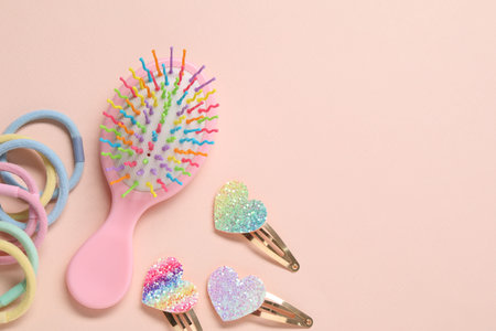 Colorful hair accessories on pink background, flat lay. Space for textの写真素材