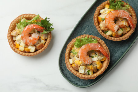 Tartlets with delicious filling on white marble table, flat layの写真素材