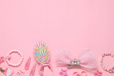 Cute hair accessories on pink background, flat lay. Space for textの写真素材
