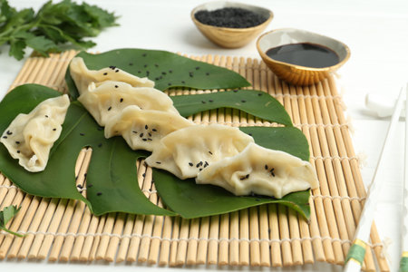 Tasty boiled gyoza (dumplings) served on white tableの写真素材