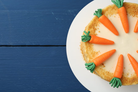 Delicious homemade carrot cake on blue wooden table, top view. Space for textの写真素材