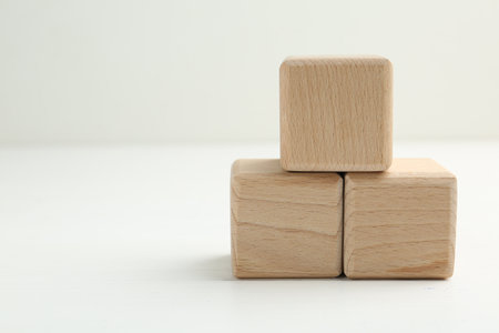Wooden cubes on white table, closeup. Space for textの写真素材