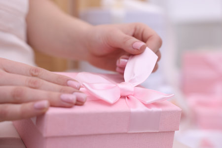 Bride opening beautiful wedding gift indoors, closeupの写真素材