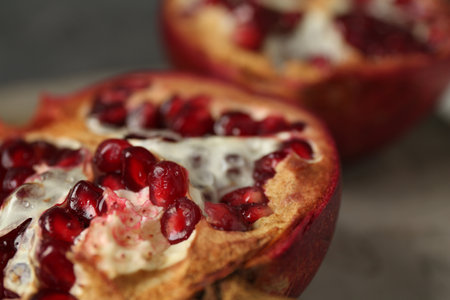 Fresh juicy pomegranates on gray table, closeupの写真素材