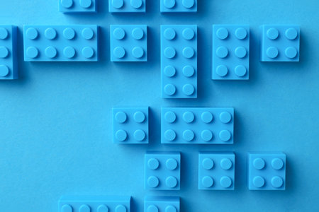Constructor toy. Many building blocks on light blue background, flat layの写真素材