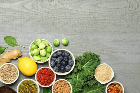 Superfood. Different healthy food products on grey wooden table, flat lay. Space for textの写真素材