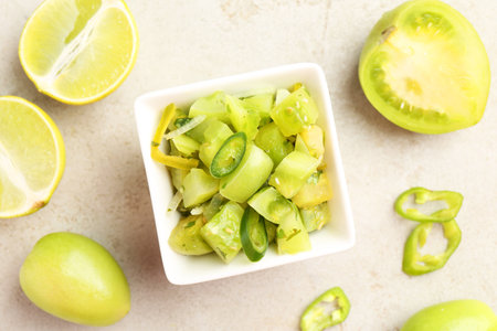 Delicious salsa in bowl and products on light textured table, flat layの写真素材