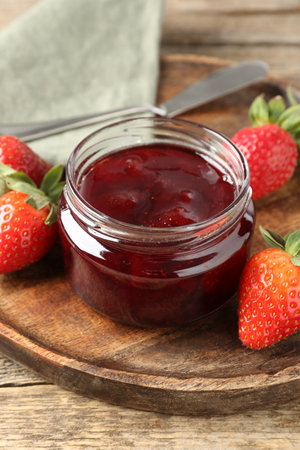 Delicious strawberry sauce and fresh berries on wooden table, closeupの写真素材