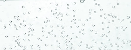 Refreshing soda water in glass against light background, closeup