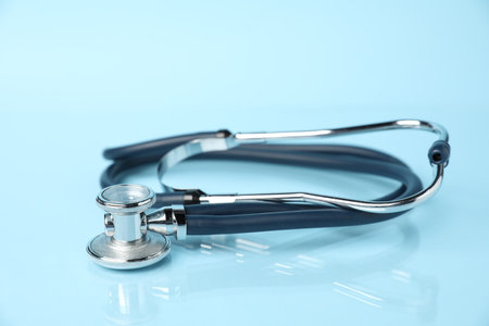 Stethoscope on light blue background, closeup. Medical toolの写真素材