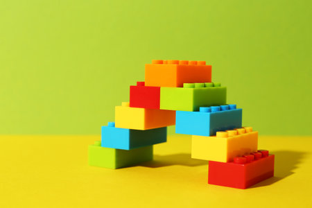 Construction toy. Figure made with building bricks on color backgroundの写真素材