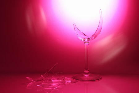 Pieces of broken wine glass against deep pink gradient background, space for text. Color tone effectの写真素材