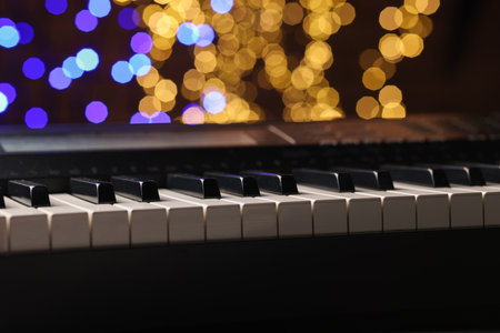 Piano against blurred lights, closeup. Bokeh effectの写真素材