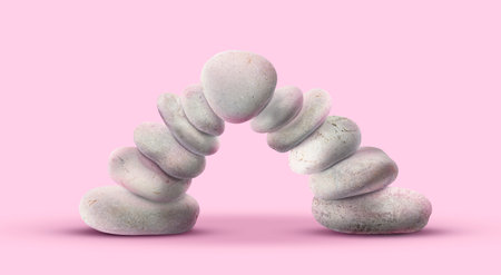 Balance shown as stacked stones on pink backgroundの写真素材