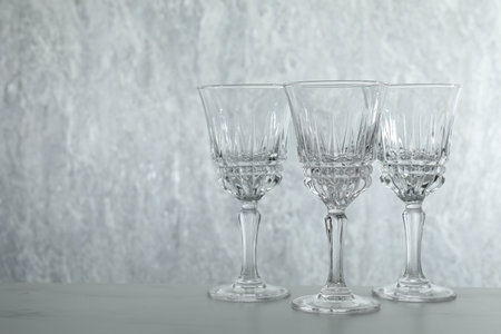 Three empty clean glasses on gray table. Space forの写真素材