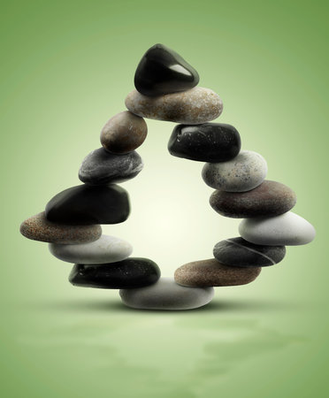 Balance shown as stacked stones on green gradient backgroundの写真素材