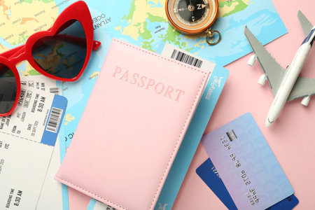 Flat lay composition with passport and ticket on pink background