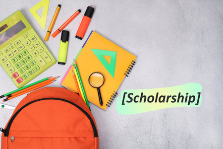 Scholarship. Flat lay composition with backpack and different school stationery on light grey tableの写真素材
