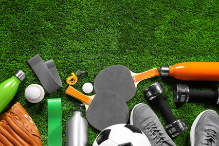 Different sports equipment on artificial grass, flat lay. Space for textの写真素材