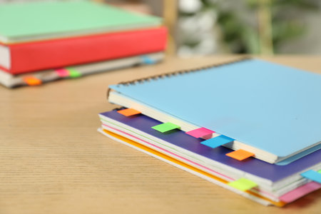 Notebooks with colorful tabs on wooden table, closeupの写真素材
