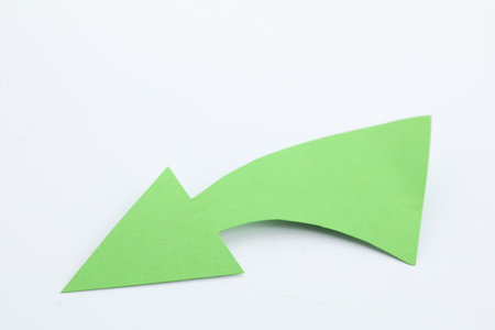 One green paper arrow isolated on whiteの写真素材