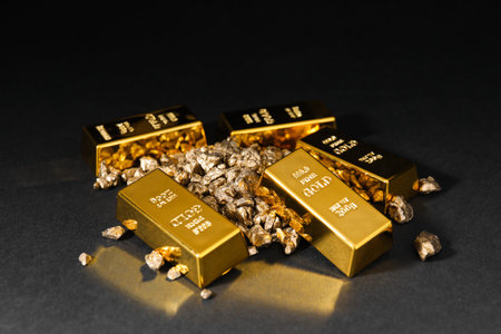 Gold nuggets and bars on black table