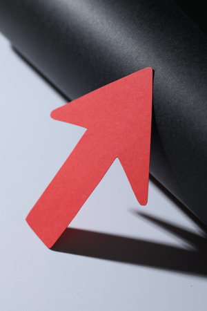 One red paper arrow on color background, closeupの写真素材