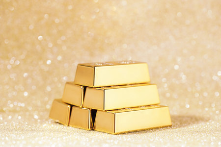 Gold bars on color glitter background, closeupの写真素材