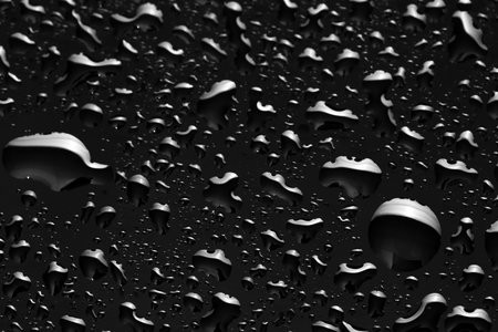 Water drops on black glass surface, closeupの写真素材