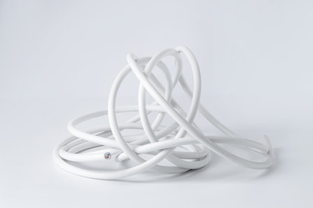 Tangled insulated electrical wire isolated on whiteの写真素材