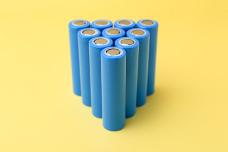 Many cell batteries on yellow background, closeupの写真素材