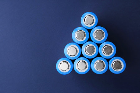 Many AA cell batteries on blue background, top view. Space for textの写真素材