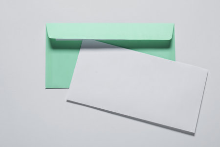 Paper envelope with letter on white background, top view. Mockup for designの写真素材