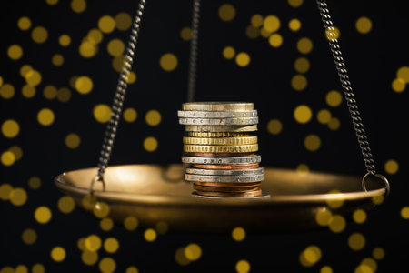 Many coins on scales against black background, closeup. Bokeh effectの写真素材