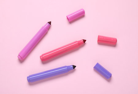 Many colorful markers on pink background, flat layの写真素材