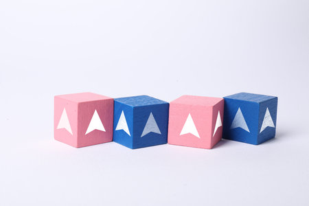 Pink and blue cubes with arrows on white background