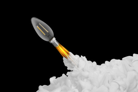 Light bulb flying like rocket with smoke and fire on black background. Concepts of idea, startup, creativity, fast successの写真素材