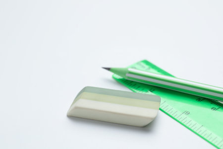 Eraser, pencil and ruler on white background, closeup. Space for text