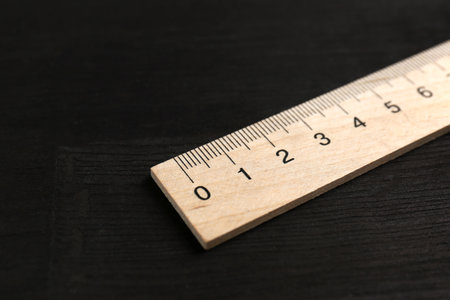 One ruler on black wooden table, closeupの写真素材