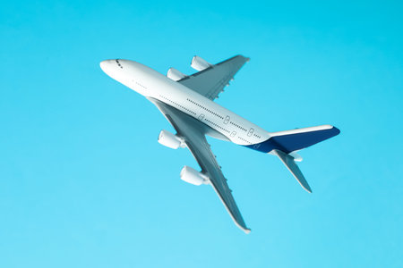 Plane model in air on light blue background