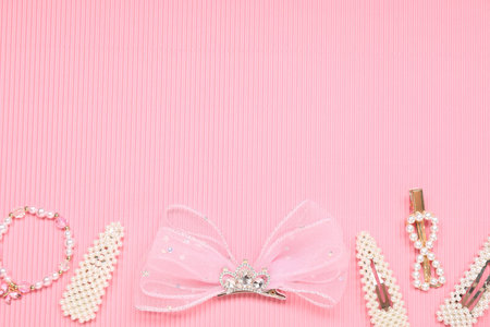 Different hair accessories on pink textured background, flat lay. Space for textの写真素材